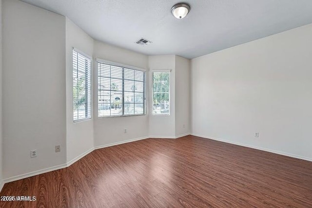 spare room with hardwood / wood-style flooring