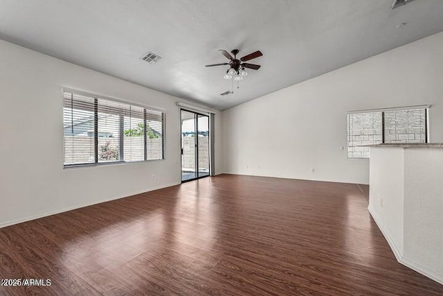 spare room featuring dark wood-type flooring and ceiling fan