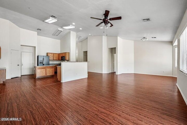 unfurnished living room with dark hardwood / wood-style floors and ceiling fan