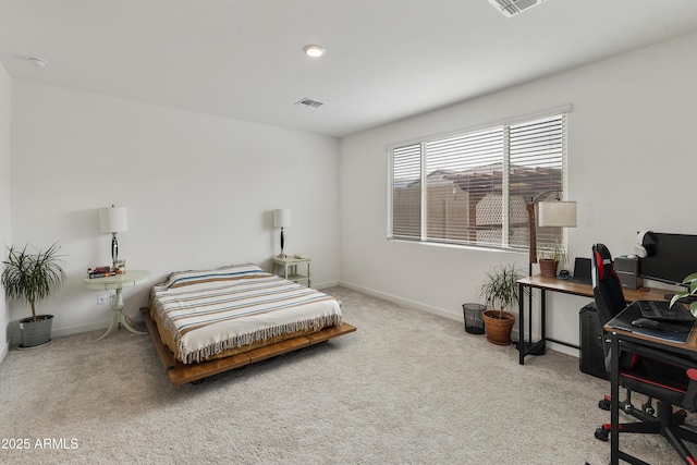 carpeted bedroom with visible vents and baseboards