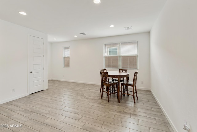 dining room with baseboards, light wood-style floors, visible vents, and recessed lighting