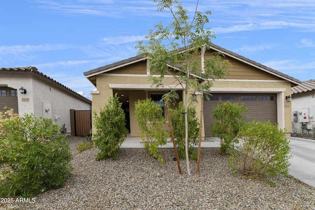 view of front of house featuring stucco siding, driveway, and a garage