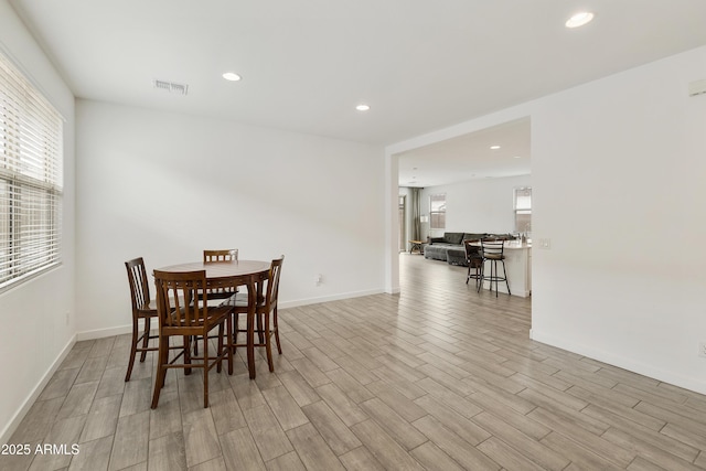 dining room featuring a wealth of natural light, light wood-style floors, and recessed lighting