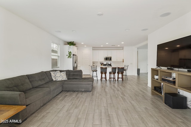 living room with recessed lighting and light wood-type flooring