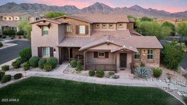 18562 N 94th St, Scottsdale, AZ 85255 - view of front facade featuring a mountain view, covered porch, stucco siding, and a front lawn