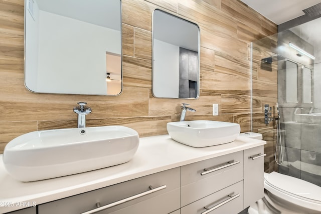 bathroom featuring vanity, tiled shower, tile walls, and toilet