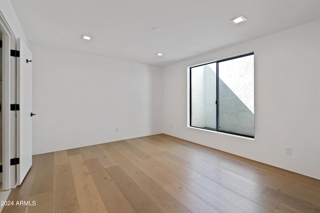 spare room with light hardwood / wood-style flooring