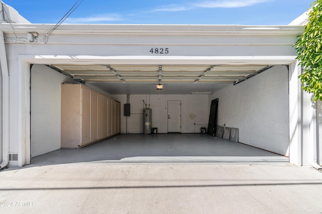 garage with a garage door opener, water heater, and a carport