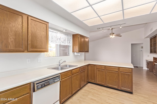 kitchen featuring white dishwasher, sink, kitchen peninsula, and light hardwood / wood-style floors