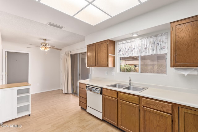 kitchen featuring dishwasher, sink, light wood-type flooring, and ceiling fan