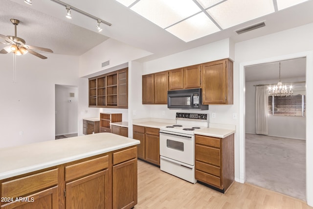 kitchen featuring white electric stove, light hardwood / wood-style flooring, ceiling fan with notable chandelier, and hanging light fixtures