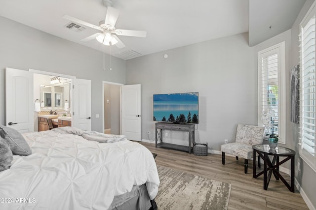 bedroom featuring hardwood / wood-style flooring, ensuite bath, and ceiling fan