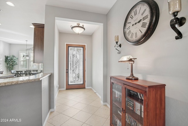 entrance foyer with a notable chandelier and light tile patterned flooring