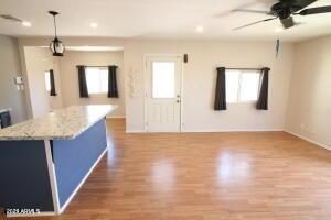 kitchen featuring a wealth of natural light, a center island, wood-type flooring, and decorative light fixtures