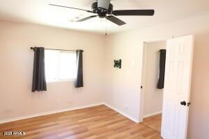 spare room with ceiling fan and light hardwood / wood-style flooring