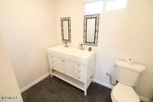 bathroom featuring toilet and vanity