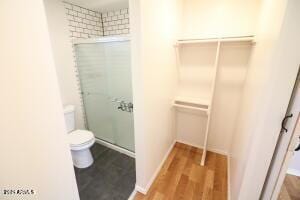 bathroom featuring hardwood / wood-style flooring and toilet