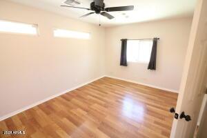 spare room with hardwood / wood-style flooring and ceiling fan