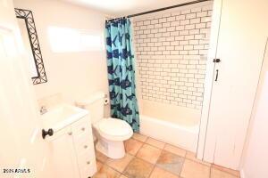 full bathroom featuring toilet, shower / tub combo, tile patterned floors, and vanity