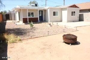 back of property featuring an outdoor fire pit