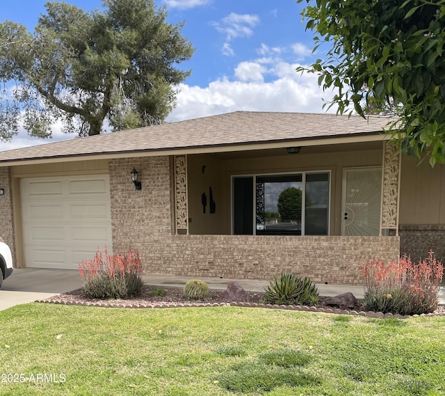 ranch-style house featuring brick siding, a shingled roof, concrete driveway, a front yard, and a garage