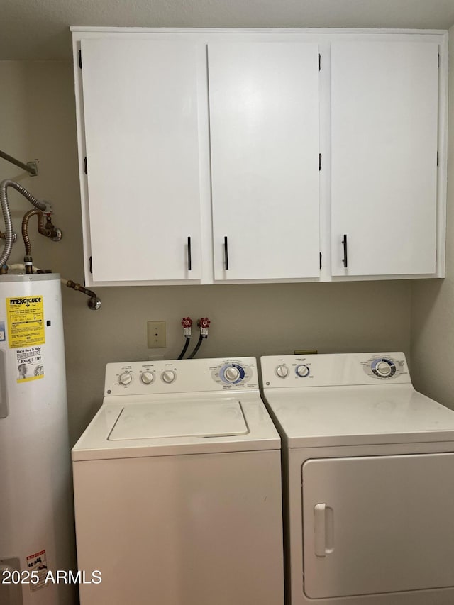 clothes washing area with cabinet space, separate washer and dryer, and electric water heater