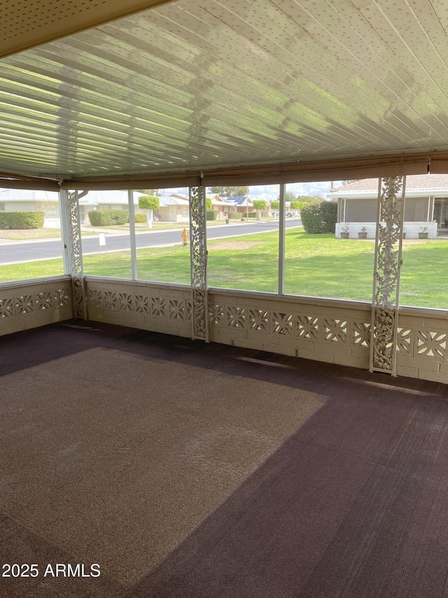 unfurnished sunroom featuring wood ceiling