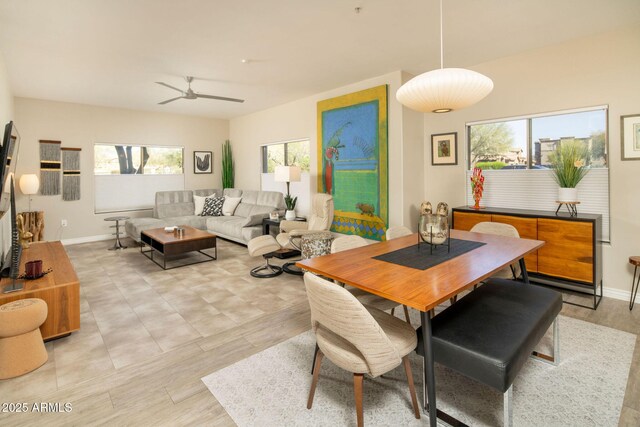 dining area featuring plenty of natural light, a ceiling fan, and baseboards