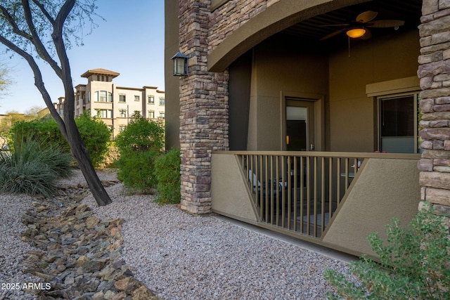view of exterior entry featuring stone siding and stucco siding