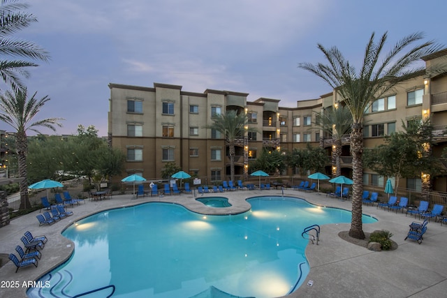 community pool featuring a patio area and fence