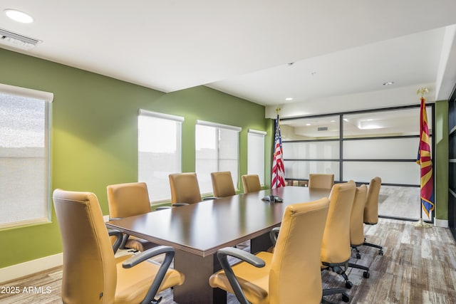 dining space with visible vents, baseboards, and wood finished floors