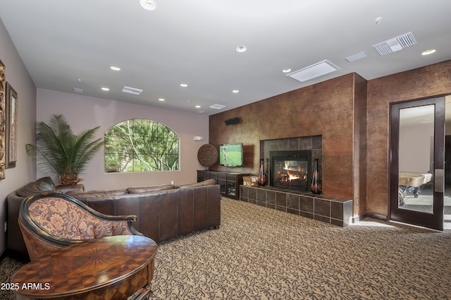 carpeted living area featuring visible vents, recessed lighting, and a fireplace