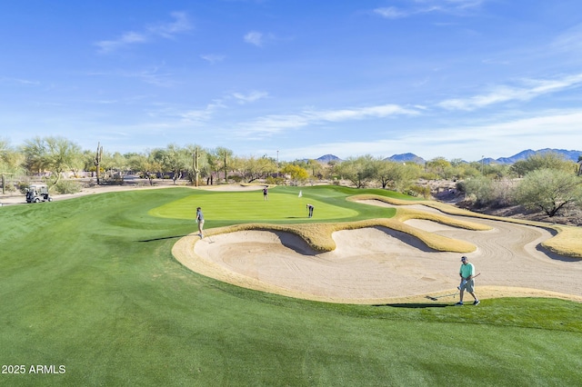 view of home's community featuring a mountain view and view of golf course