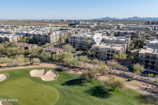 birds eye view of property featuring a mountain view, golf course view, and a view of city