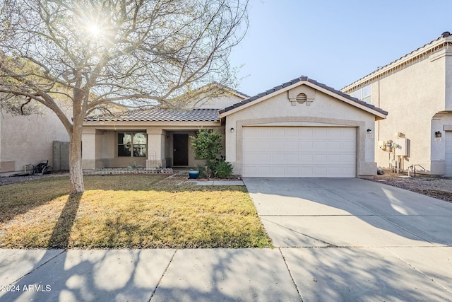 view of front of home with a garage and a front lawn