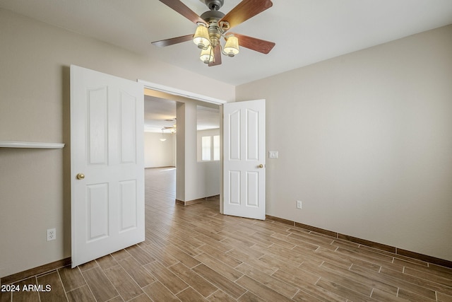 unfurnished bedroom featuring light hardwood / wood-style flooring and ceiling fan