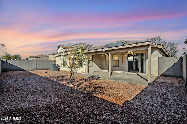 555 W Racine Loop, Casa Grande, AZ 85122 - back of house with stucco siding, a ceiling fan, roof mounted solar panels, and a fenced backyard