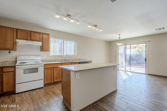 kitchen featuring sink, a center island, white electric stove, hardwood / wood-style floors, and decorative light fixtures