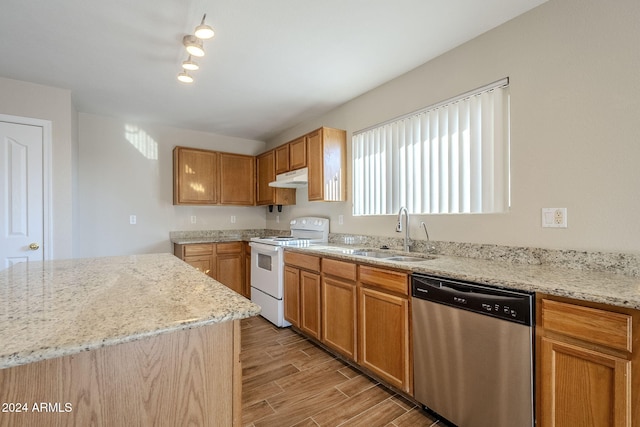 555 W Racine Loop, Casa Grande, AZ 85122 - kitchen with stainless steel dishwasher, electric range, under cabinet range hood, light wood finished floors, and light stone counters