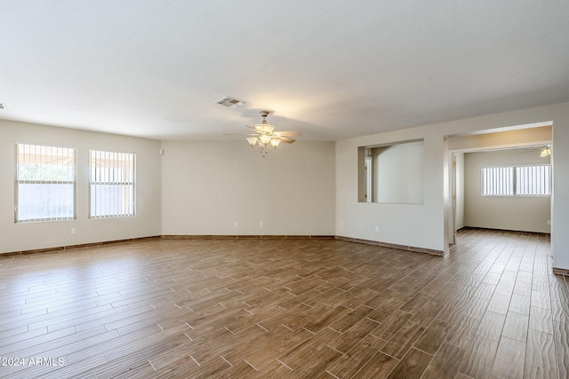 spare room with ceiling fan and wood-type flooring