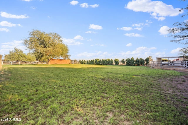 view of yard featuring a rural view and an outdoor structure