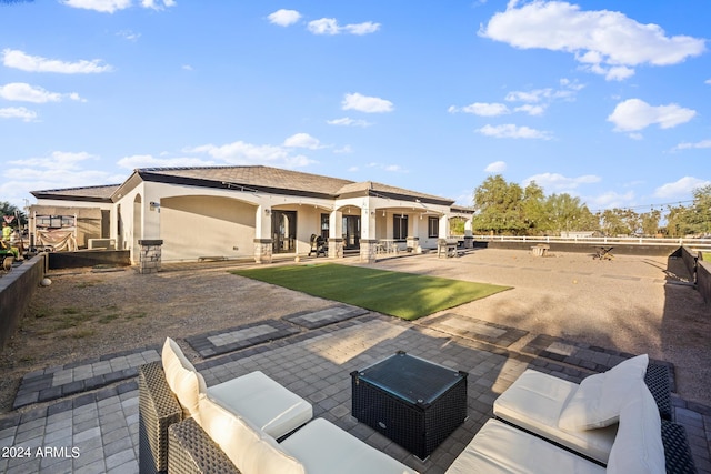 17617 W Rose Ln, Waddell, AZ 85355 - rear view of house featuring a patio, fence, an outdoor hangout area, and stucco siding
