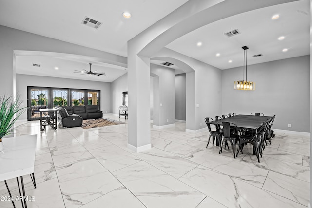 dining area with ceiling fan with notable chandelier