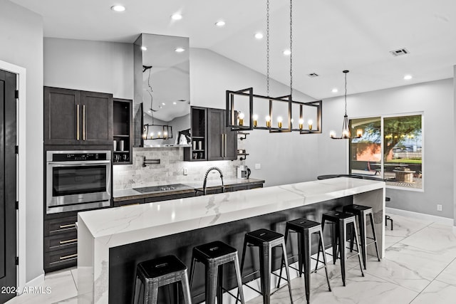 17617 W Rose Ln, Waddell, AZ 85355 - kitchen with decorative backsplash, black electric stovetop, visible vents, oven, and a notable chandelier