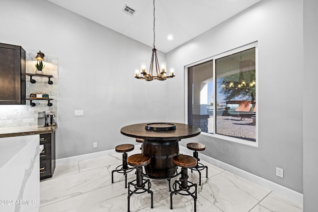 17617 W Rose Ln, Waddell, AZ 85355 - dining room with lofted ceiling, visible vents, a chandelier, baseboards, and marble finish floor