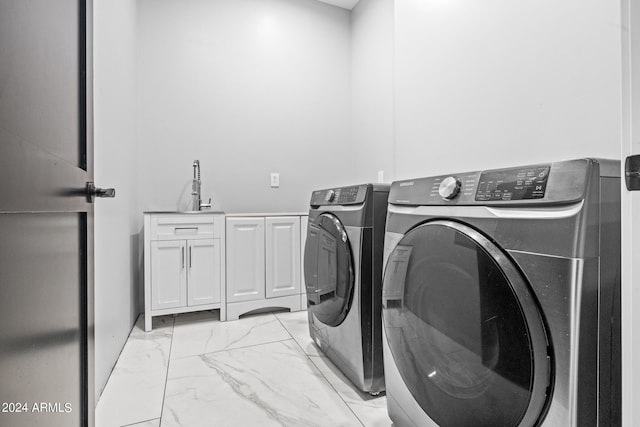 17617 W Rose Ln, Waddell, AZ 85355 - laundry room featuring a sink, cabinet space, washing machine and clothes dryer, and marble finish floor
