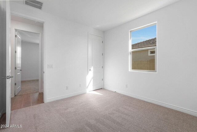 unfurnished bedroom featuring light colored carpet