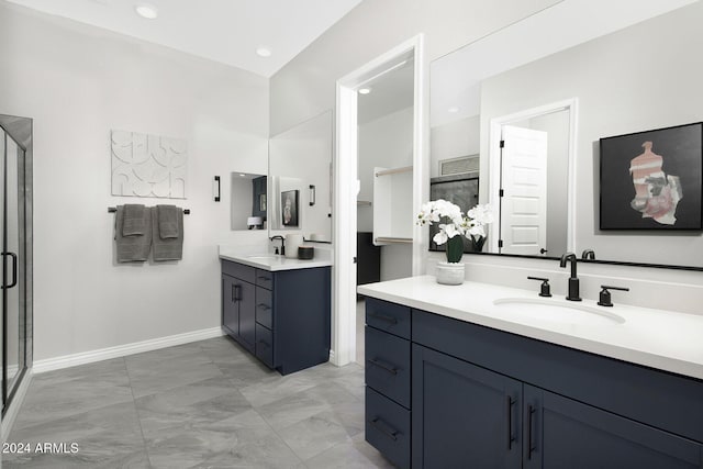 bathroom featuring vanity and a shower with door