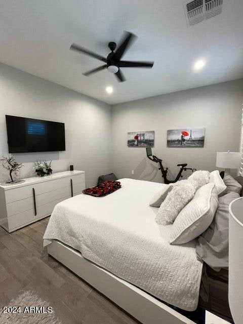 bedroom with ceiling fan and hardwood / wood-style flooring