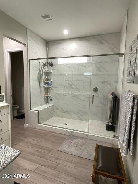 bathroom with toilet, vanity, and walk in shower